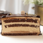 Close-up of a layered chocolate cake with a blurred background
