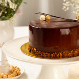 Chocolate cake on a white stand with a blurred background