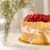 Decorative cake with strawberries on a white plate, featuring the brand 'Melo'.