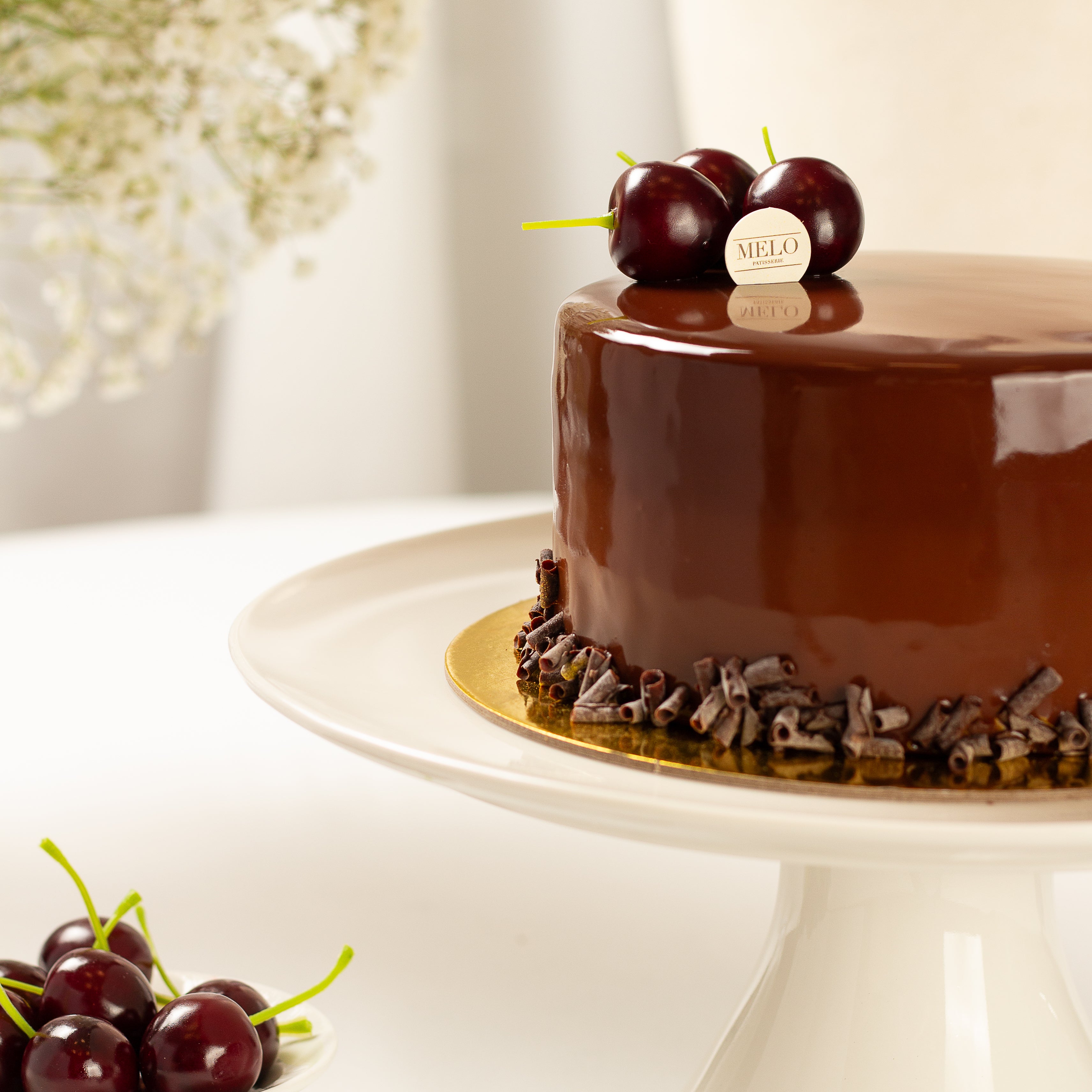 Chocolate cake with cherries on a white stand