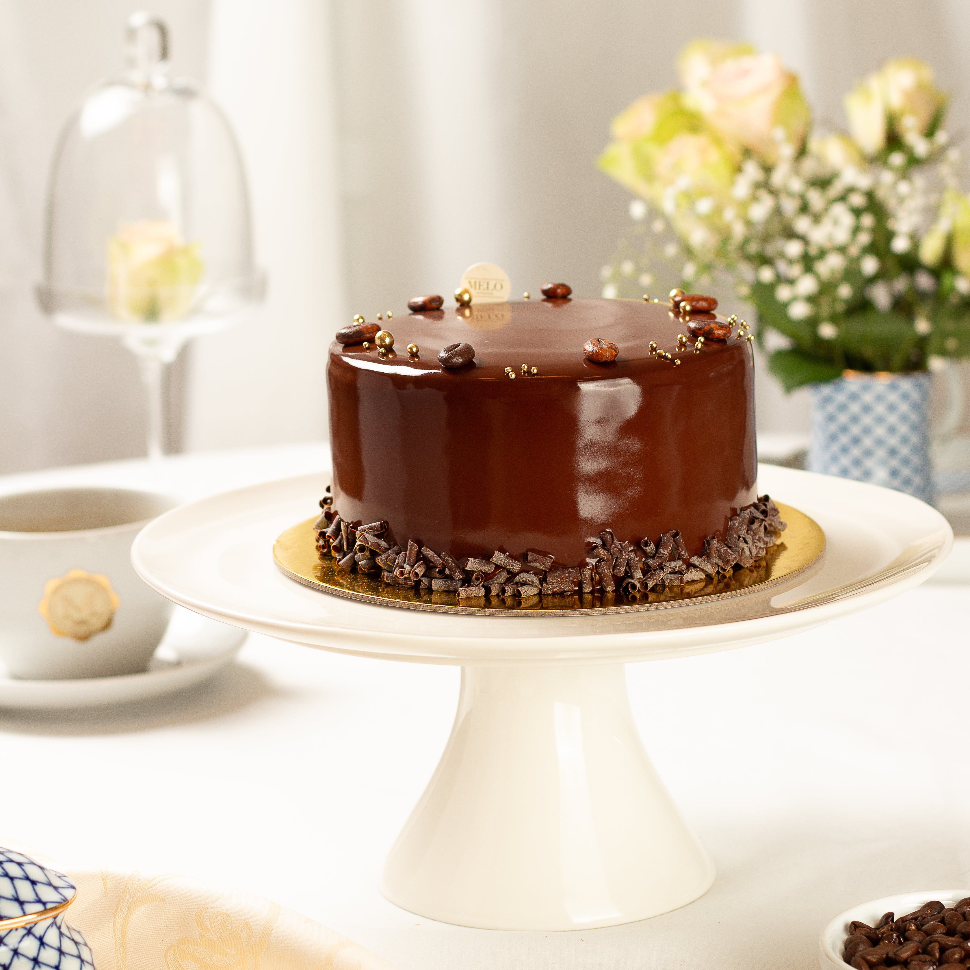 Chocolate cake on a white stand with a blurred background