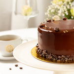 Chocolate cake with a cup of coffee on a white surface