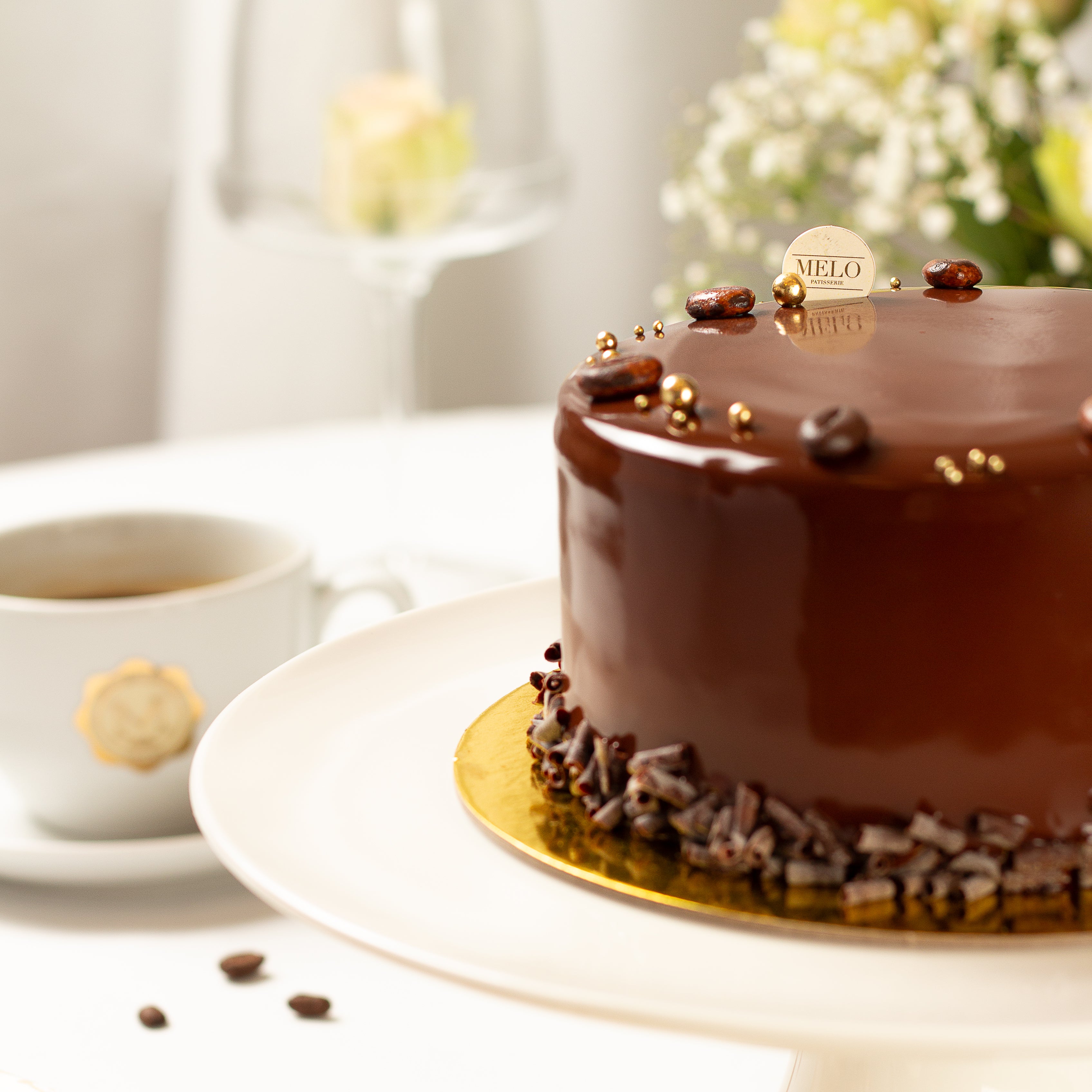 Chocolate cake with a cup of coffee on a white surface