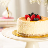 Cheesecake with berries on a white plate with a blurred background
