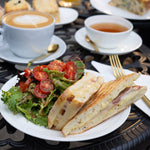 Ciabatta sandwich with salad and beverages on a table