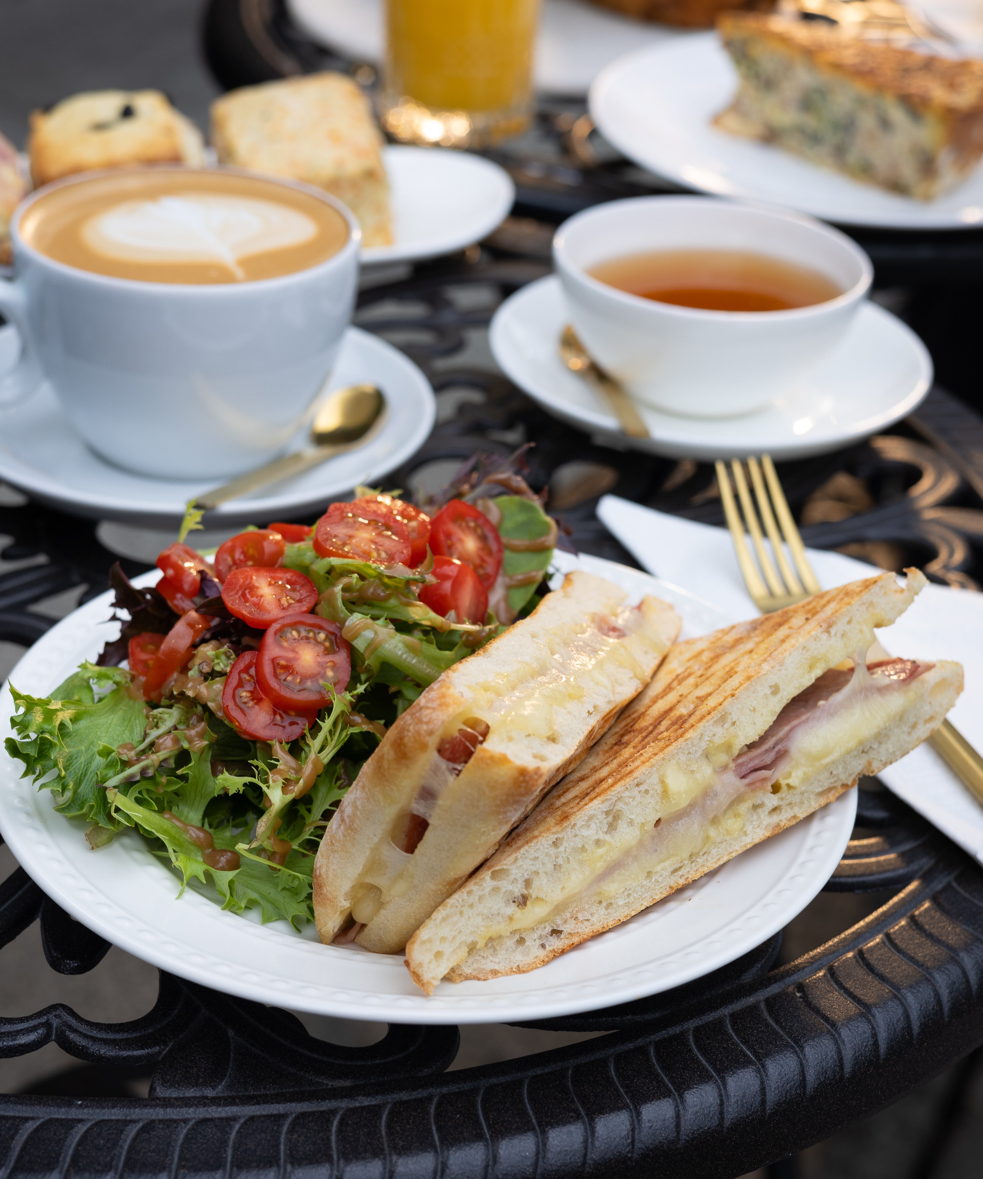 Ciabatta sandwich with salad and beverages on a table