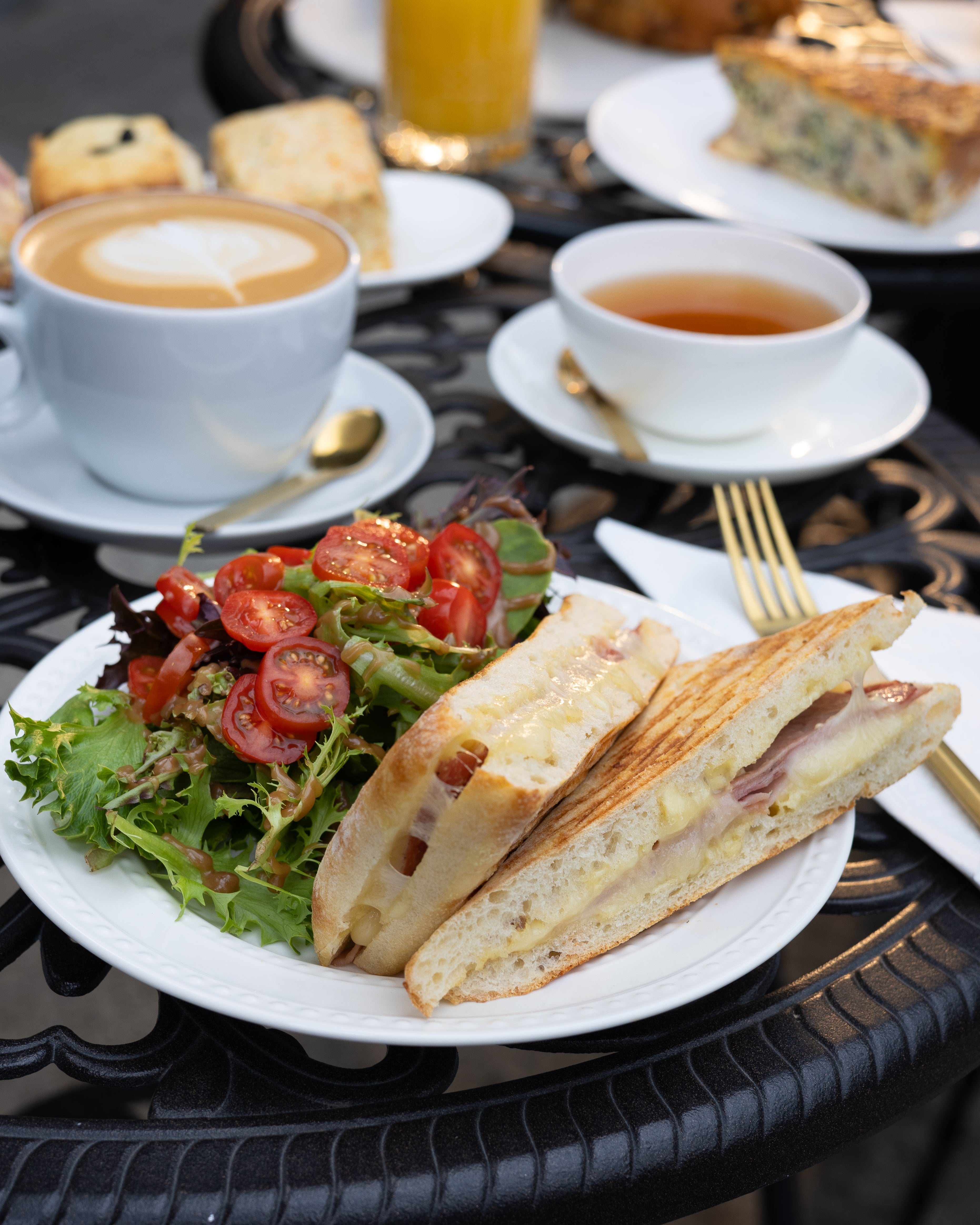Ciabatta sandwich with salad and beverages on a table