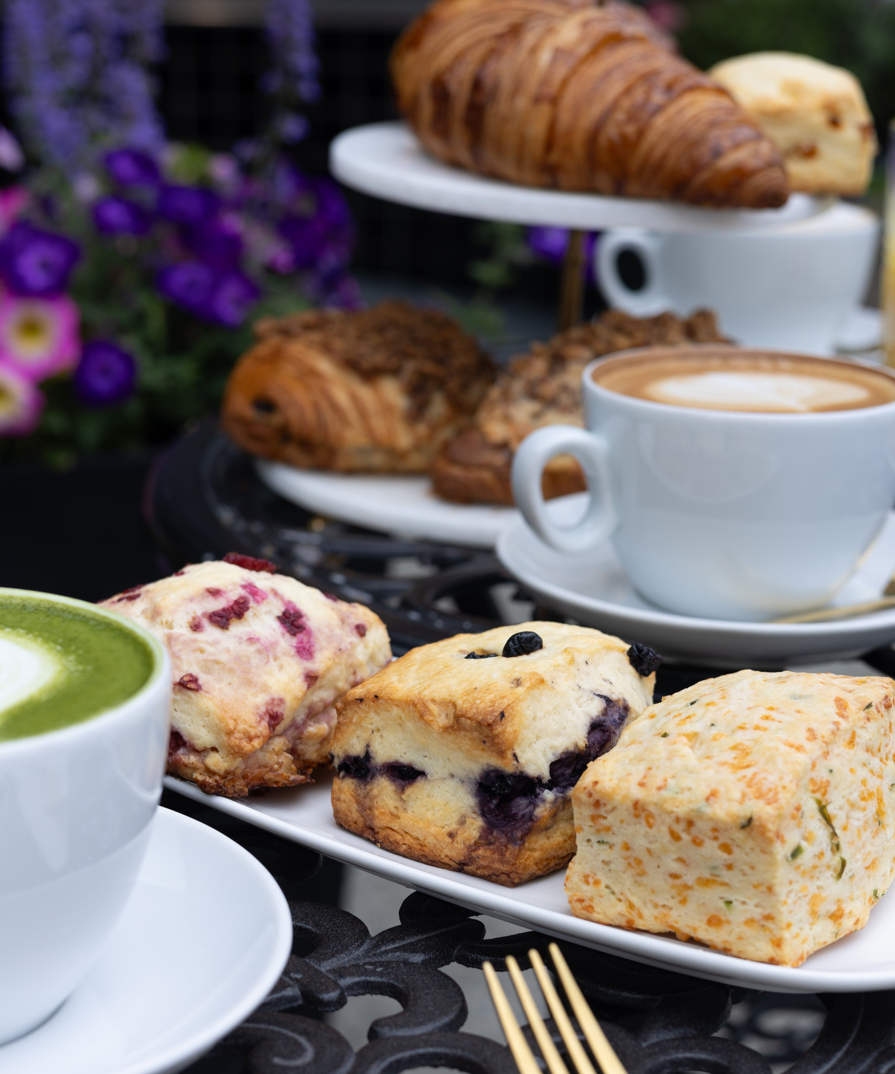 Assorted pastries and a cup of coffee on a table with a blurred background