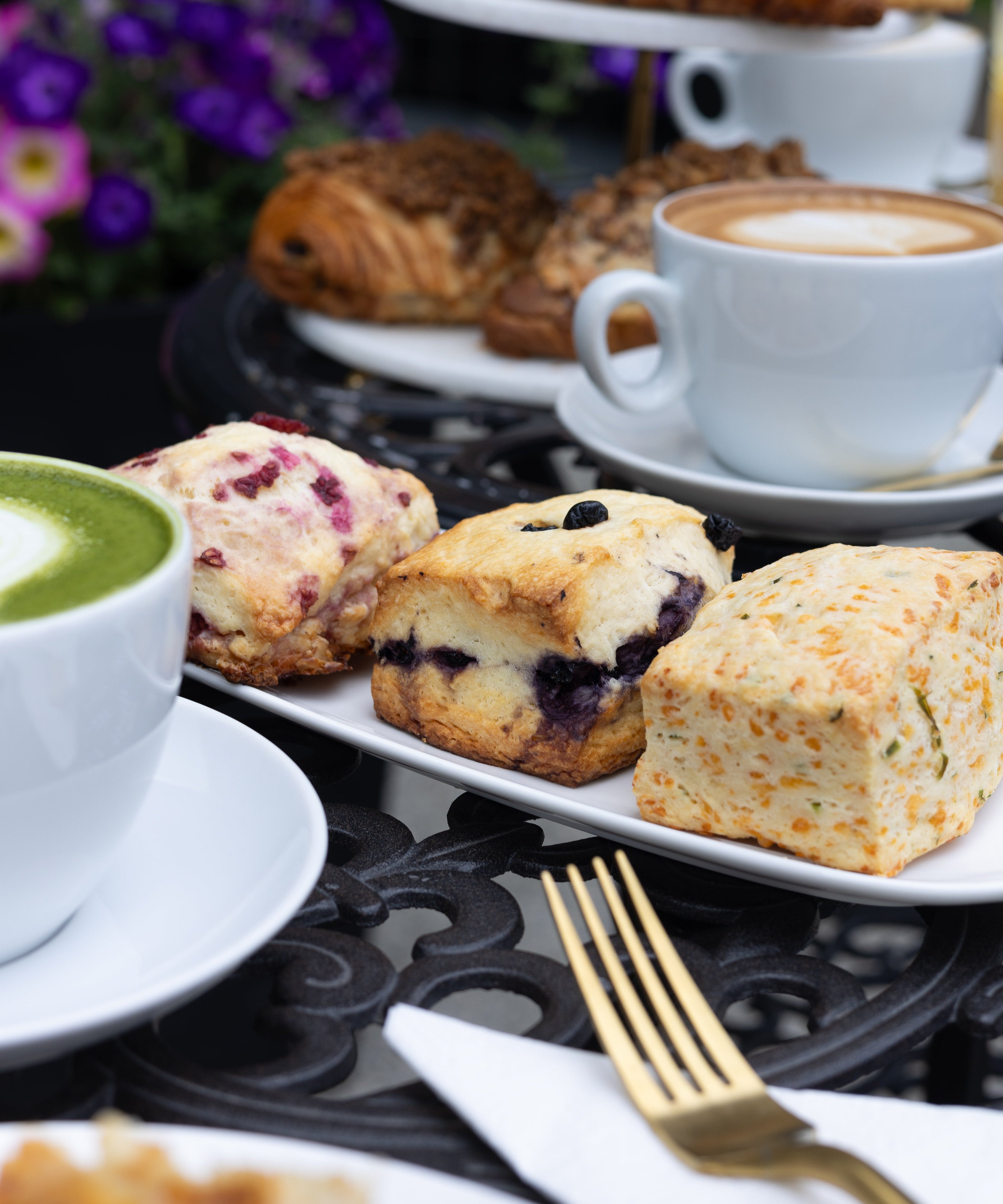 Assorted pastries and a cup of coffee on a table with a blurred background