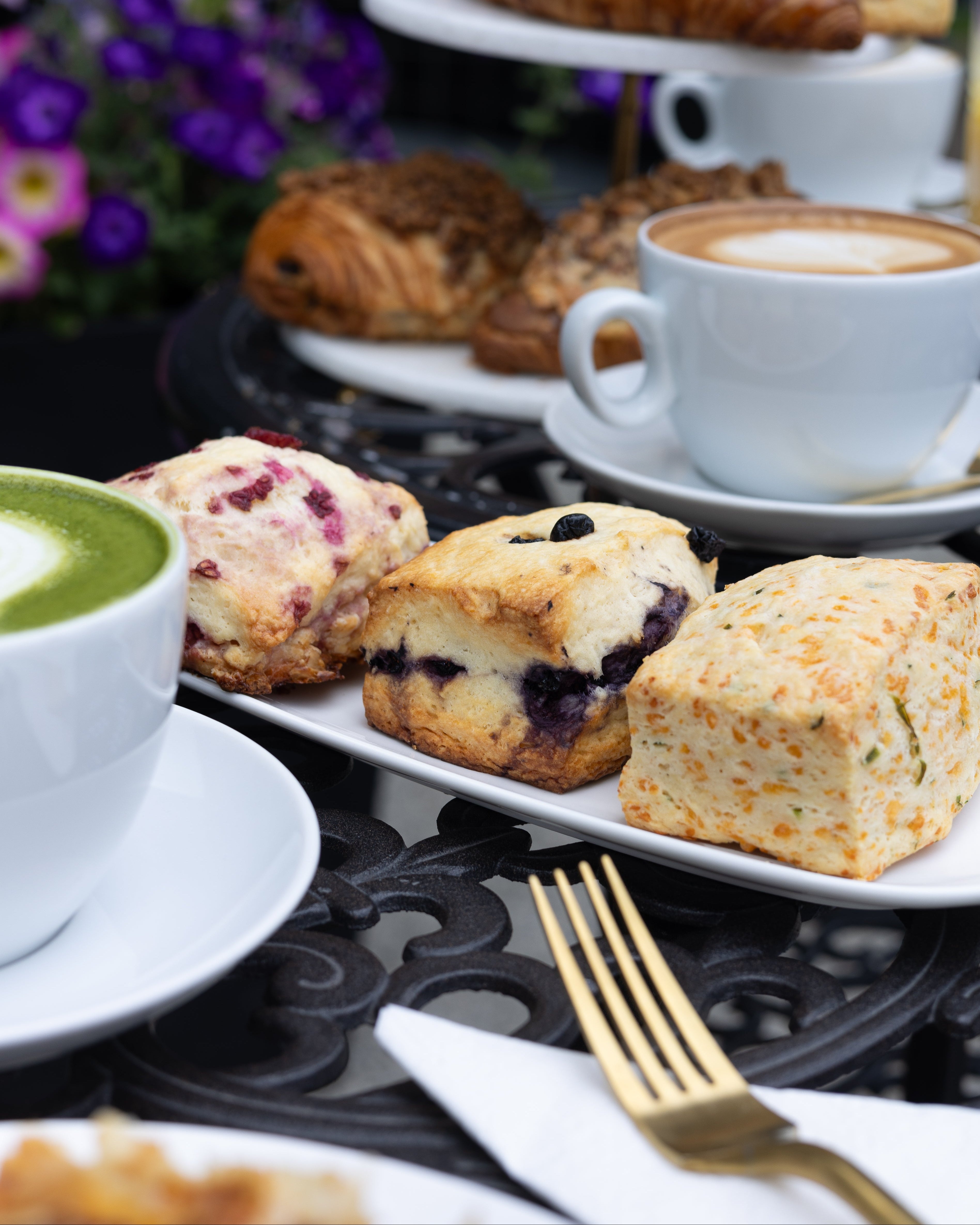 Assorted pastries and a cup of coffee on a table with a blurred background