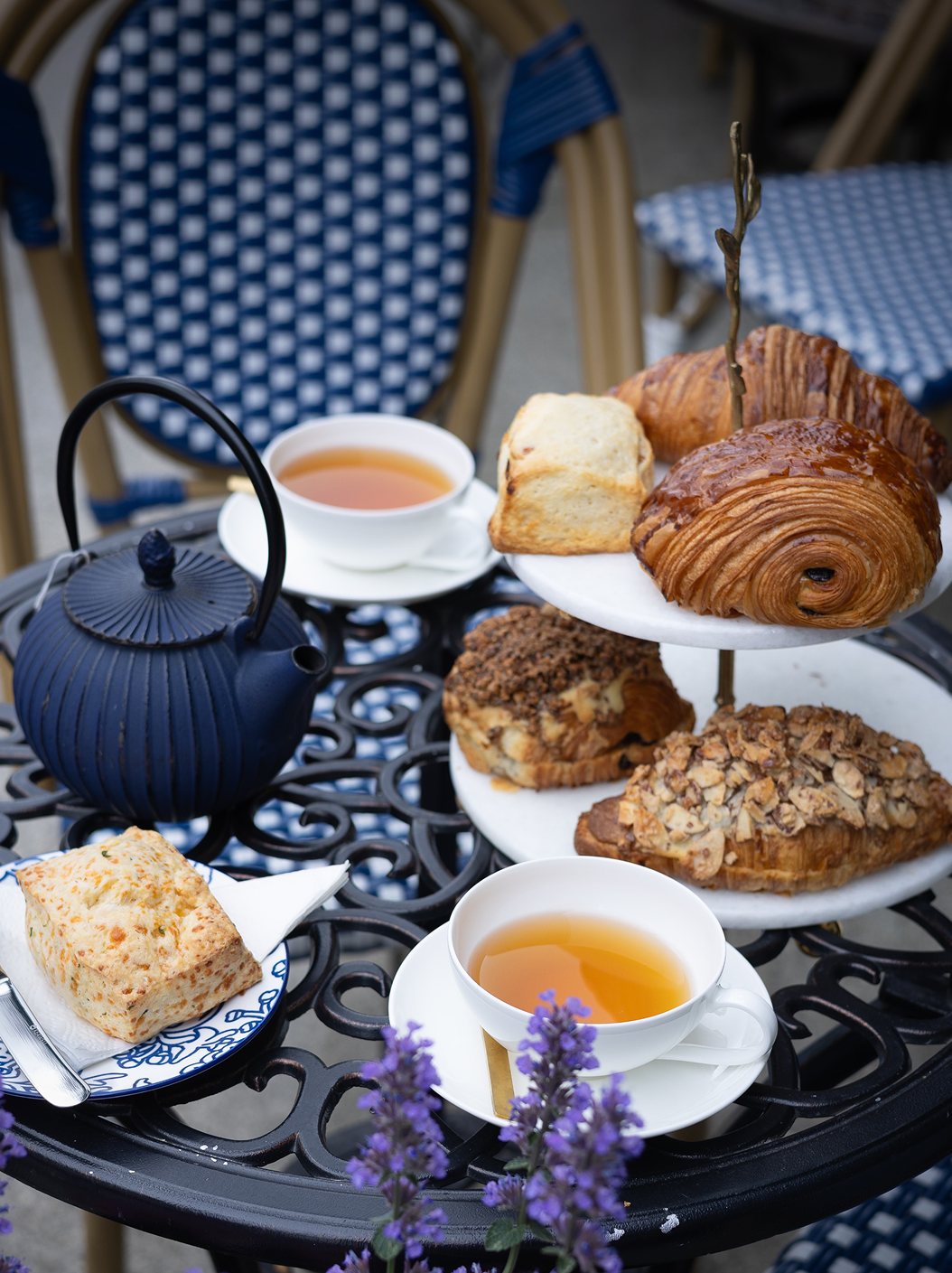 Tea set with pastries on a table outdoors